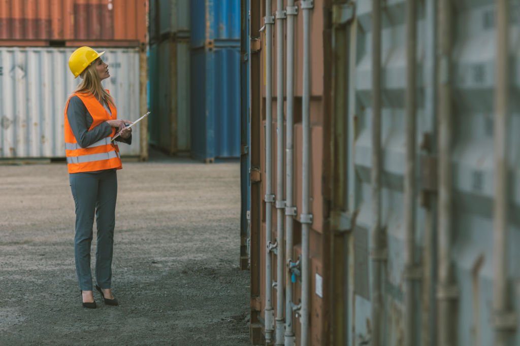 Female inspector checking cargo containers