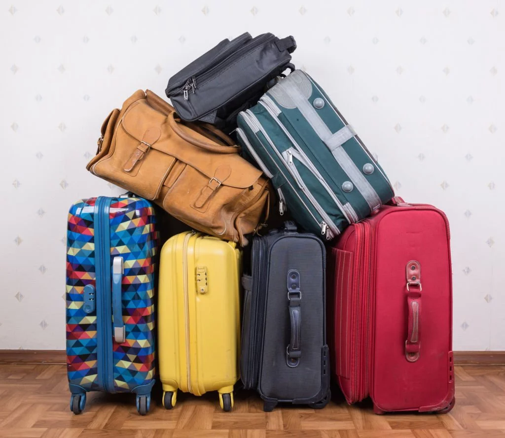 A stack of used suitcases