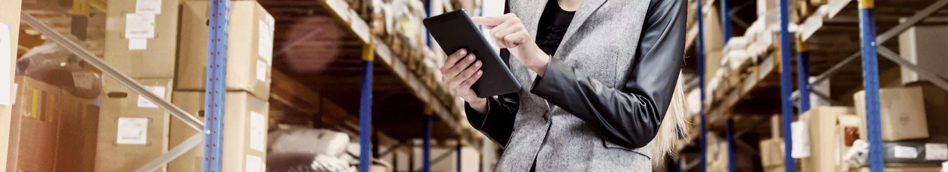 Woman on Tablet in Warehouse