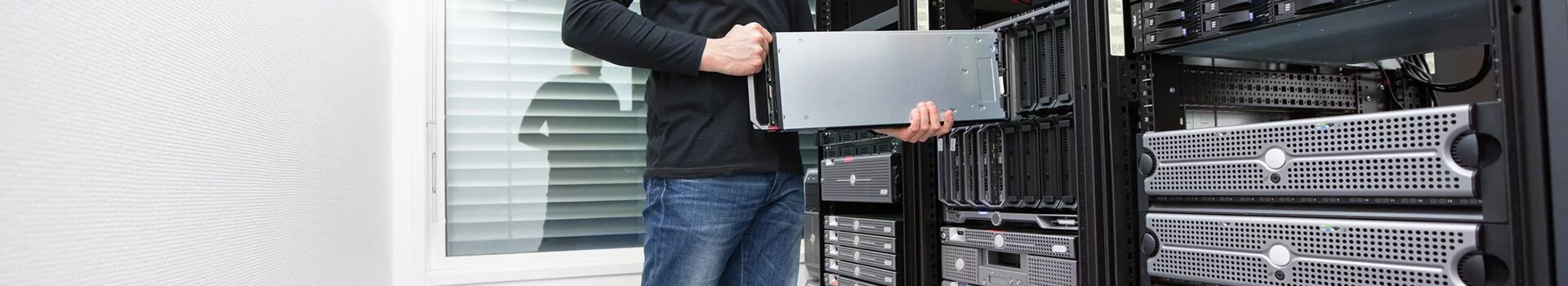 Man Loading a Server onto a Server Stack