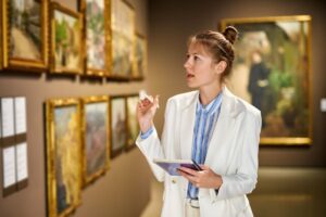 Woman visitor in the historical museum looking at pictures